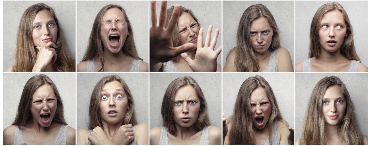 10 headshots of a dark haired woman expressing a variety of emotions.