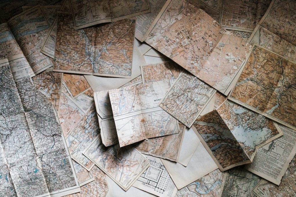 a photograph of numerous maps overlapping one another