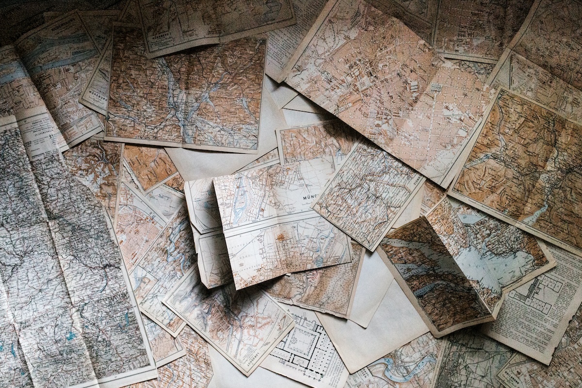 a photograph of numerous maps overlapping one another