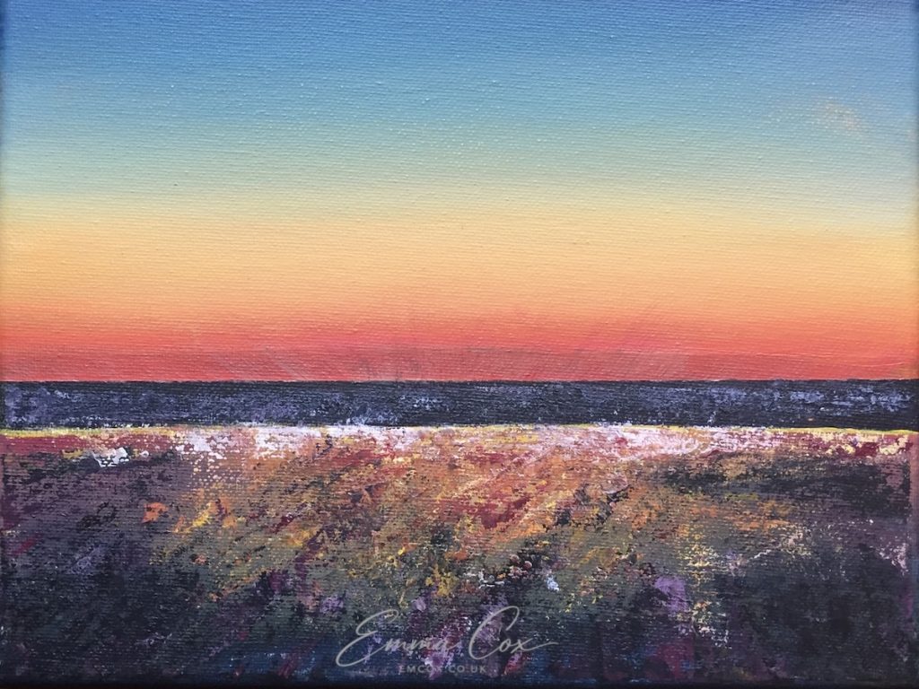 An acrylic Cornish seascape painting after dusk. The sun has set behind the sea and the clear sky is lit up in rainbow-like hues from red at the horizon to orange, yellow, green and deep blue at the top of the painting. The reddish colours are reflected in the wet sand.