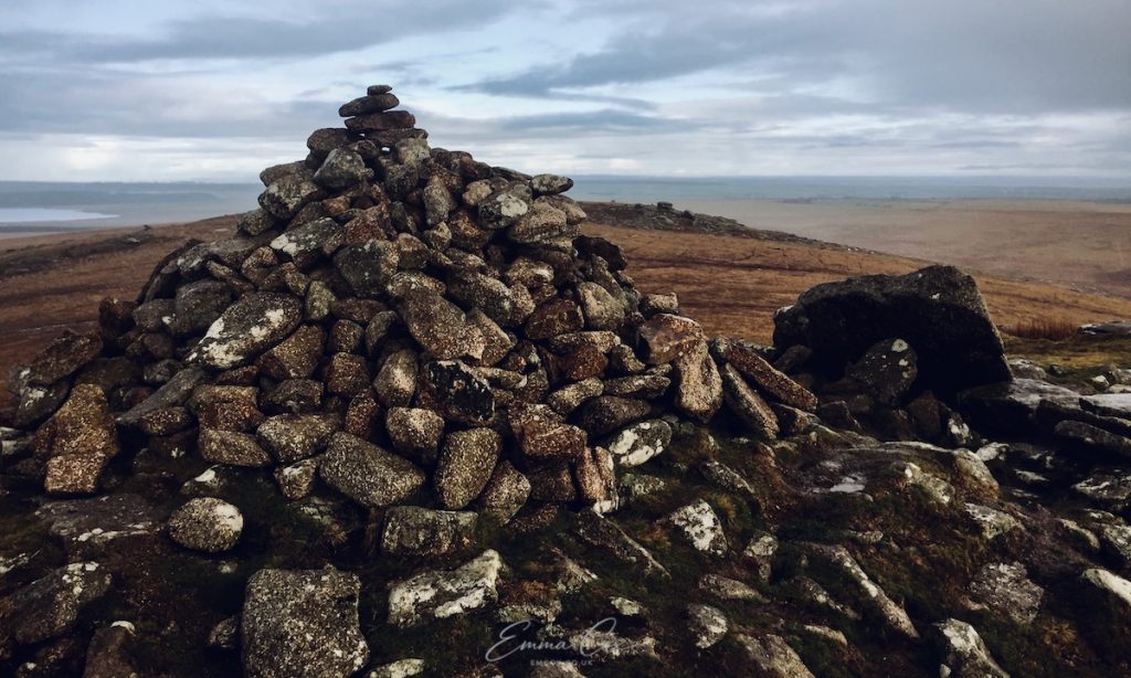 Photograph of a cairn, a human made rock pile, at the summit of a tor overlooking Bodmin Moor, Cornwall