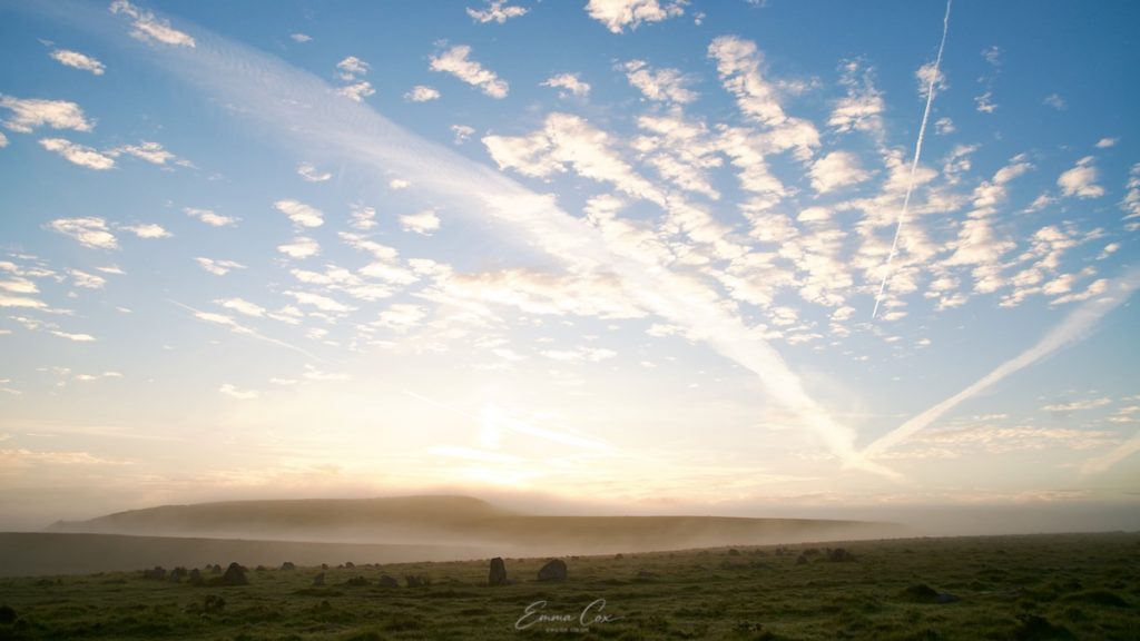 Photograph for a Cornish sunrise across Bodmin Moor. Scattered stones in open grassland beneath a big sky.