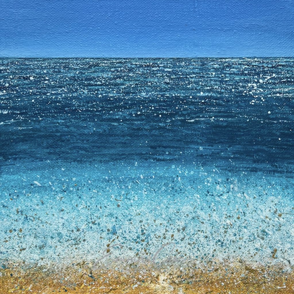 An acrylic Cornish seascape with a wave crashing on a sandy shore. The horizon is clear blue sky and the sun glitters on the water.