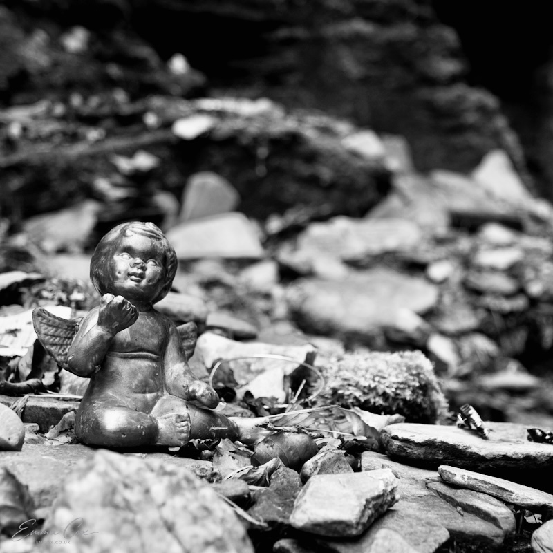 a cherub offering left on rocks