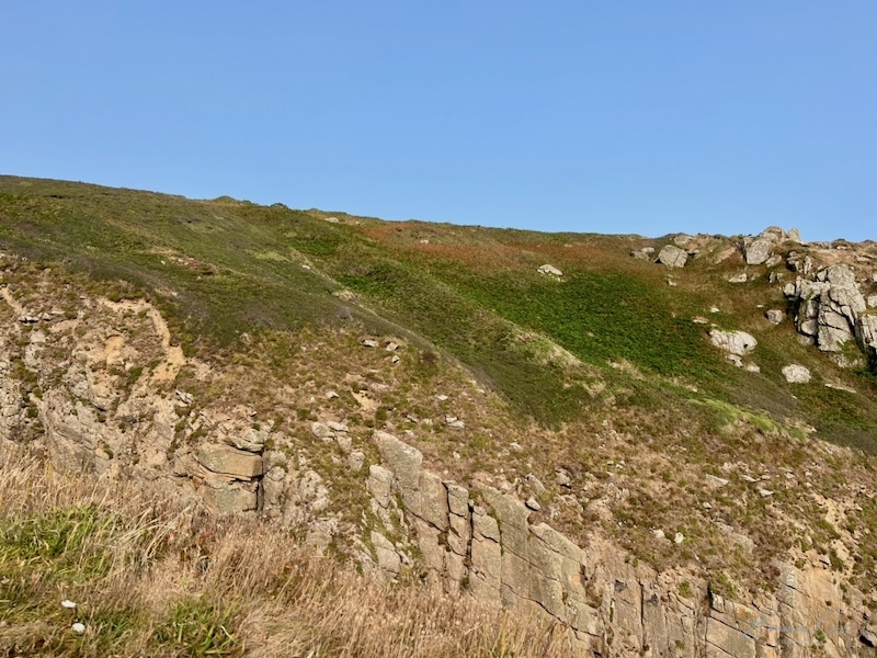 Two ramparts and ditches leading to the cliff edge
