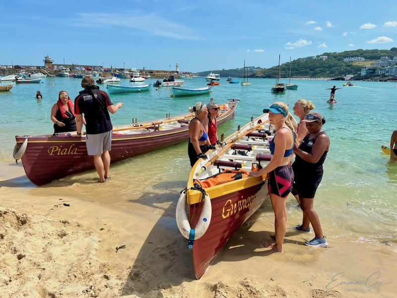 two gigs on the shoreline of a small harbour